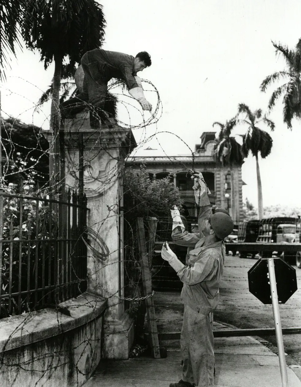 U.S. soldiers surround Iolani Palace with barbed wire during the rule of martial law in 1942.